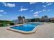 Beautiful outdoor pool with clear blue water, surrounded by palm trees and lounge chairs at 10037 62Nd N Ter # 9, St Petersburg, FL 33708