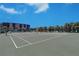 Well-maintained tennis court with green surface, set against a clear blue sky and palm trees at 10037 62Nd N Ter # 9, St Petersburg, FL 33708