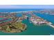 Expansive aerial view showcasing a coastal community with beautiful waterways, beaches, and golf course at 10355 Paradise Blvd # 412, Treasure Island, FL 33706