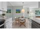 Cozy dining area with modern lighting adjacent to kitchen for easy entertaining at 10355 Paradise Blvd # 412, Treasure Island, FL 33706