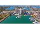 A waterfront condo building with a pool, boat docks, and lush landscaping offers luxurious living at 10355 Paradise Blvd # 412, Treasure Island, FL 33706