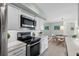Bright kitchen boasts stainless steel appliances and a view of the charming dining area at 10355 Paradise Blvd # 412, Treasure Island, FL 33706