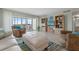 Relaxing living room with cozy seating, views to outdoor balcony, and light, modern decor at 10355 Paradise Blvd # 412, Treasure Island, FL 33706