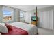 Bright main bedroom with water views, shuttered windows, neutral walls, and double door closet at 10355 Paradise Blvd # 412, Treasure Island, FL 33706