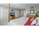 Well-lit main bedroom features neutral walls, wood furniture, and coastal decor, with a double door closet at 10355 Paradise Blvd # 412, Treasure Island, FL 33706