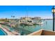 Scenic marina view with boats docked, water views and community pool on a sunny day at 10355 Paradise Blvd # 412, Treasure Island, FL 33706