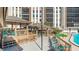 Inviting pool deck with shaded seating areas, lounge chairs, and lush green landscaping at 10355 Paradise Blvd # 412, Treasure Island, FL 33706