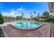 Outdoor pool surrounded by lounge chairs, gazebo and lush landscaping under a clear blue sky at 10355 Paradise Blvd # 412, Treasure Island, FL 33706