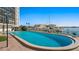 Community pool with views of the marina featuring a clear blue sky, and boat docks at 10355 Paradise Blvd # 412, Treasure Island, FL 33706