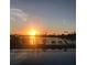 Stunning sunset reflecting on the water with palm trees and seating along the waterfront at 10355 Paradise Blvd # 412, Treasure Island, FL 33706