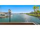 Scenic view of a waterfront area from a balcony, with boats, palm trees, and buildings in the distance at 10355 Paradise Blvd # 412, Treasure Island, FL 33706