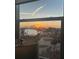 Charming sunset through window offering peaceful water views, waterfront homes and golden horizon at 10355 Paradise Blvd # 412, Treasure Island, FL 33706