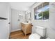 Updated bathroom featuring wood grain vanity, contemporary fixtures, and a bright, clean aesthetic at 10825 Oakdale Ave, Port Richey, FL 34668
