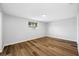 Bright, empty bedroom with natural light and wood floors, ready for personalization and comfort at 10825 Oakdale Ave, Port Richey, FL 34668