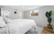 Bright bedroom featuring light walls, natural light, minimalist decor, and an inviting, airy feel at 10825 Oakdale Ave, Port Richey, FL 34668