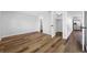 Neutral bedroom featuring wood floors and access to an ensuite bathroom and kitchen at 10825 Oakdale Ave, Port Richey, FL 34668