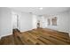 Spacious bedroom features wood floors, access to screened porch, bathroom, and adjoining dining area at 10825 Oakdale Ave, Port Richey, FL 34668