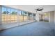 Enclosed patio with a ceiling fan and a view of the fenced backyard at 10825 Oakdale Ave, Port Richey, FL 34668