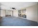 Spacious enclosed patio with a ceiling fan and sliding glass doors to the backyard at 10825 Oakdale Ave, Port Richey, FL 34668
