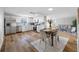 Modern kitchen featuring stainless steel appliances, white cabinetry, and open layout to the living room at 10825 Oakdale Ave, Port Richey, FL 34668