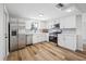 Bright kitchen boasts stainless steel appliances, white cabinets, and a complementing backsplash for a modern look at 10825 Oakdale Ave, Port Richey, FL 34668