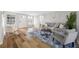 Bright and open living room with hardwood floors, modern furnishings, and natural light at 10825 Oakdale Ave, Port Richey, FL 34668