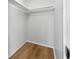 A walk-in closet featuring a simple rod shelf and wood-look flooring at 10825 Oakdale Ave, Port Richey, FL 34668