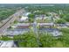 Overhead view of condos near lush trees, green spaces, a community pool, and parking at 1100 E Bay Dr # 60, Largo, FL 33770