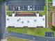 An aerial view of a building roof with many A/C units, parking and lawn at 1100 E Bay Dr # 60, Largo, FL 33770