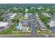 Elevated view of condo units by a canal, featuring a community pool and tennis courts at 1100 E Bay Dr # 60, Largo, FL 33770