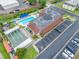 An aerial view of a community pool, shuffleboard court, gazebo, parking and lawn at 1100 E Bay Dr # 60, Largo, FL 33770