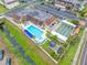 An aerial view of a community pool, shuffleboard court, gazebo, parking and lawn at 1100 E Bay Dr # 60, Largo, FL 33770