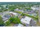 Wide aerial view of condos with parking, roads, and surrounding trees, with a marked unit at 1100 E Bay Dr # 60, Largo, FL 33770