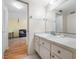 Bathroom sink with cabinets and view to living area at 1100 E Bay Dr # 60, Largo, FL 33770