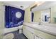 Bathroom with a moon and stars-themed shower curtain, toilet, and vanity sink at 1100 E Bay Dr # 60, Largo, FL 33770