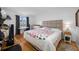 Bright bedroom with a comfortable bed, wooden floors, a desk, and natural light from a window at 1100 E Bay Dr # 60, Largo, FL 33770