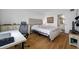 Bedroom with hardwood floors, neutral walls, a comfortable bed, a desk, and en suite bathroom at 1100 E Bay Dr # 60, Largo, FL 33770