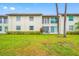 A condo building with a lawn and shrubs at 1100 E Bay Dr # 60, Largo, FL 33770
