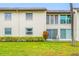 A two-story condo with a grassy yard and shrubs at 1100 E Bay Dr # 60, Largo, FL 33770