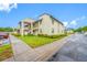 A well-manicured lawn and shrubbery accent this two-story condo building's exterior at 1100 E Bay Dr # 60, Largo, FL 33770