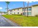 A condo exterior with a lush green lawn at 1100 E Bay Dr # 60, Largo, FL 33770
