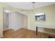 Dining area looking to kitchen and bathroom featuring wood laminate floors at 1100 E Bay Dr # 60, Largo, FL 33770