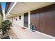 Exterior entryway to condo unit featuring neutral colors, utility closet, and well maintained landscaping at 1100 E Bay Dr # 60, Largo, FL 33770