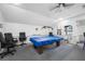 Spacious game room with a pool table under a unique light fixture, ceiling fan, and seating at 1100 E Bay Dr # 60, Largo, FL 33770