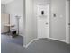 Hallway leading to sauna, scale, and neutral walls with contrasting trim and a gray floor at 1100 E Bay Dr # 60, Largo, FL 33770