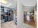 Kitchen with stainless steel refrigerator, range, and view to living space with sliding doors to lanai at 1100 E Bay Dr # 60, Largo, FL 33770