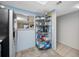 Kitchen shelving holds dishes and cooking supplies against blue walls and tile flooring at 1100 E Bay Dr # 60, Largo, FL 33770