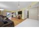 Living room with brown couches, wood floors, a large TV, and a sliding glass door at 1100 E Bay Dr # 60, Largo, FL 33770