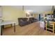 A living room features hardwood floors, couches, and a sliding glass door at 1100 E Bay Dr # 60, Largo, FL 33770