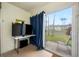 Patio with a sliding glass door, black curtains, a table, and a chair at 1100 E Bay Dr # 60, Largo, FL 33770
